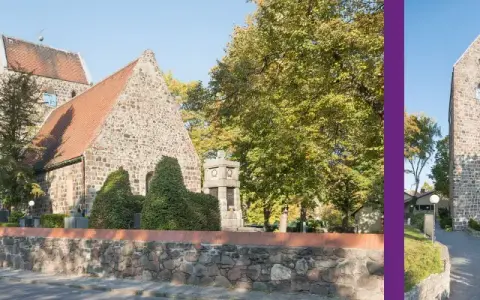 Die alte Dorfkirche mit ihrem markanten Turm und roten Ziegeldach, umgeben von Bäumen im Herbstlaub.